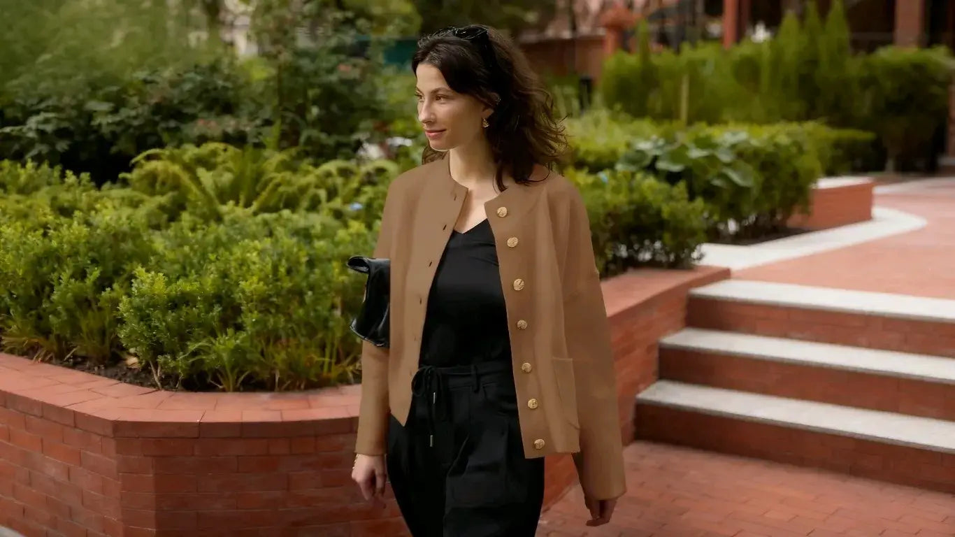 A woman wearing a cicybell brown sweater was walking in the park.