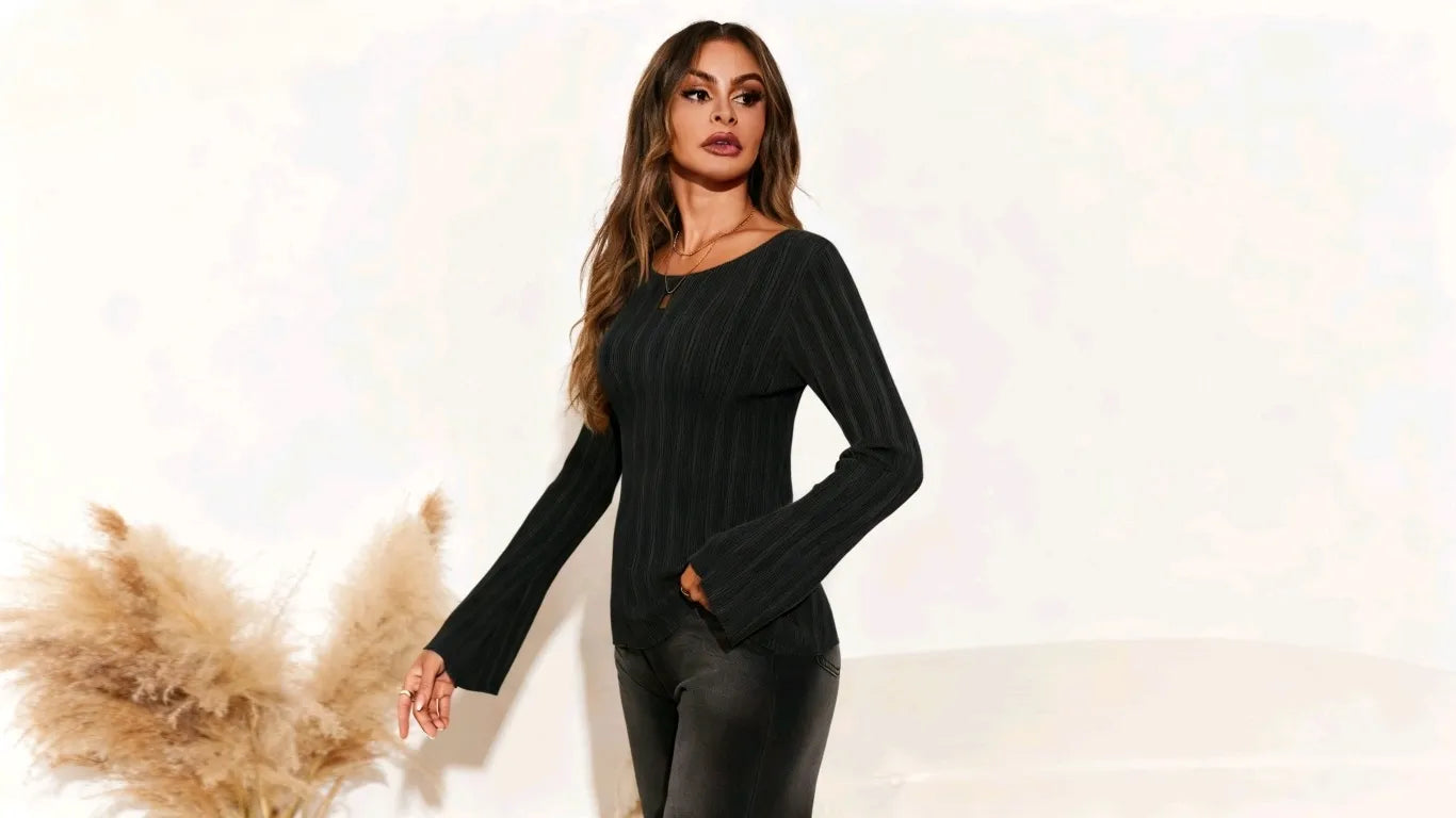 A woman is wearing a black cicybell pullover at home.