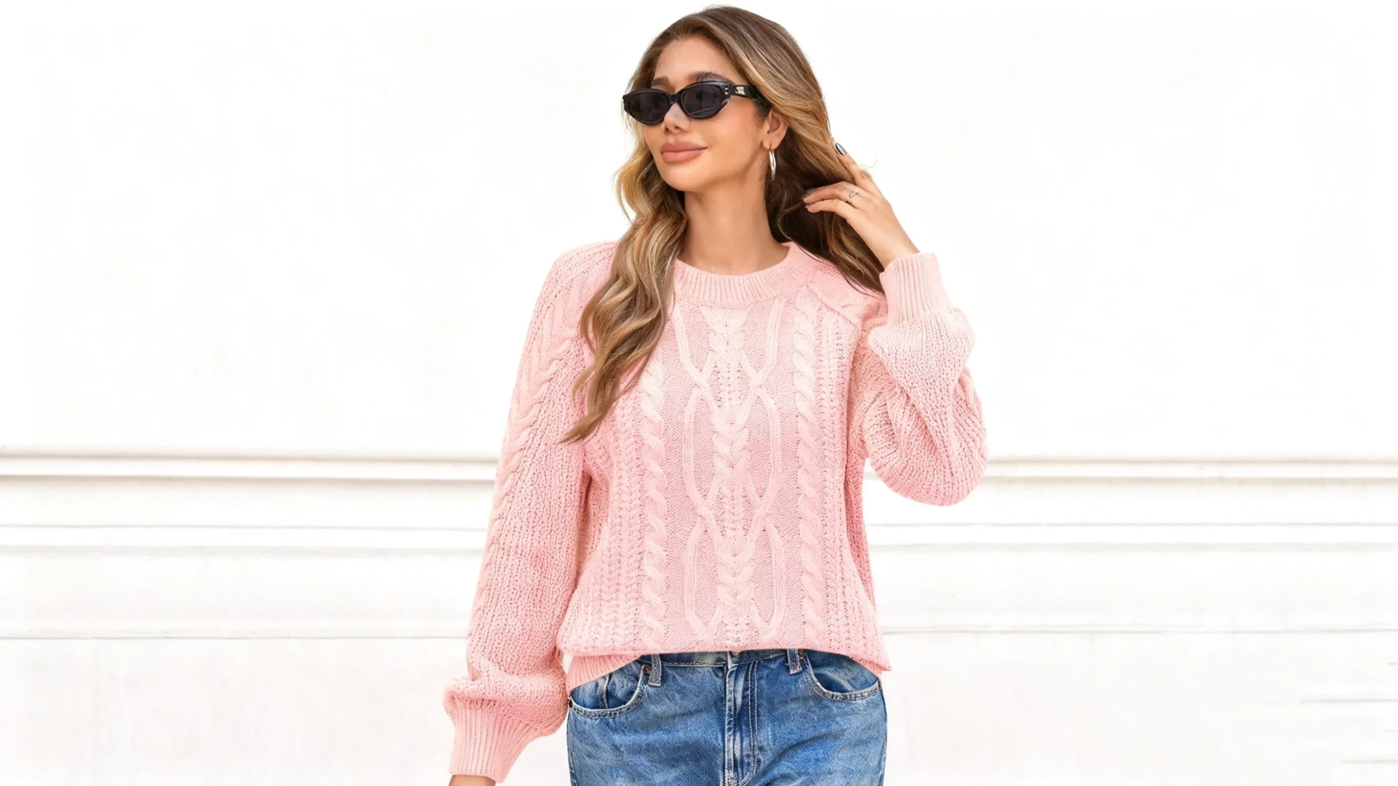 A woman wearing the Cicy Bell Women’s Pink Cable Sweater goes shopping outdoors.