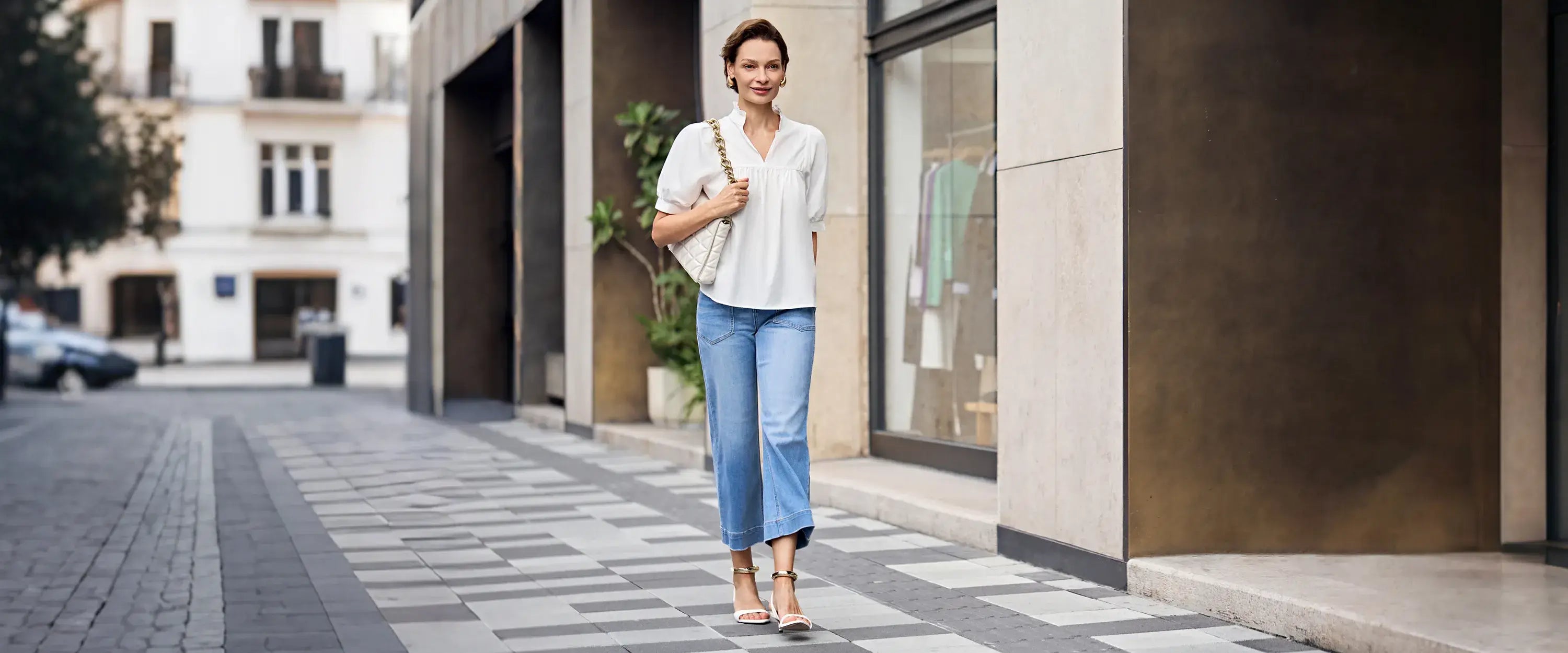 A woman is out shopping wearing a V-neck shirt and jeans.