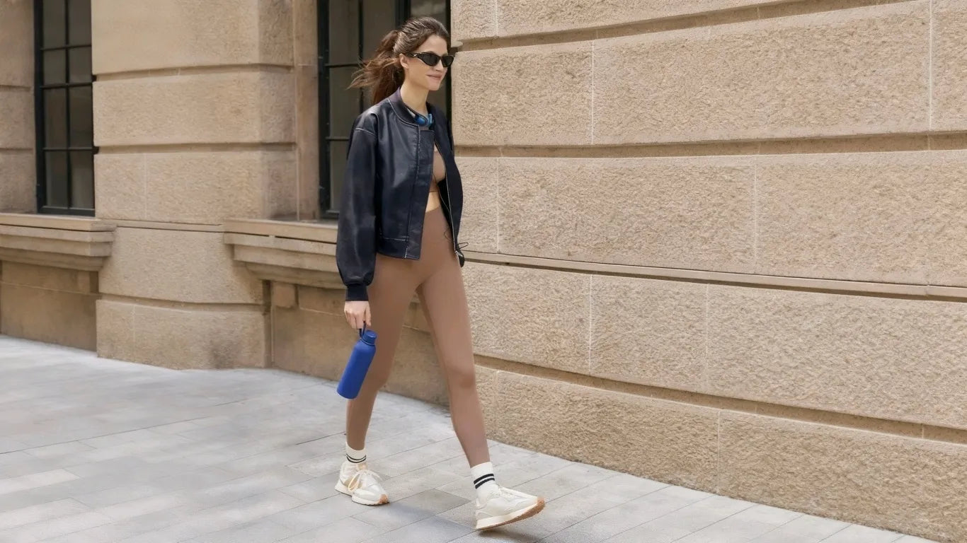A woman wearing a cicybell blue bomber jacket goes out shopping
