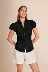 Professional woman wearing a smart casual black 100% cotton puff sleeve button down shirt