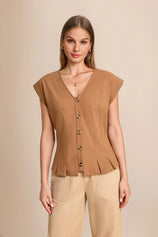 Professional woman wearing a dark khaki 100% cotton V-neck vest with cap sleeves