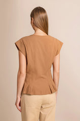 Back view of a women's tailored cotton vest showing the flattering cinched waist and cropped ruffle hem