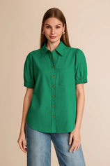 Professional woman wearing a vibrant emerald green puff short sleeve button-down shirt
