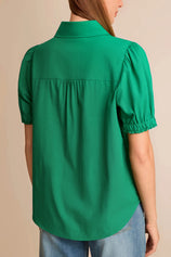 Back view of a flowy green cotton viscose blend blouse with short puff sleeves
