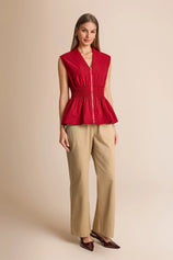 Summer 2026 smart casual outfit featuring a red smocked zipper top paired with wide-leg camel trousers