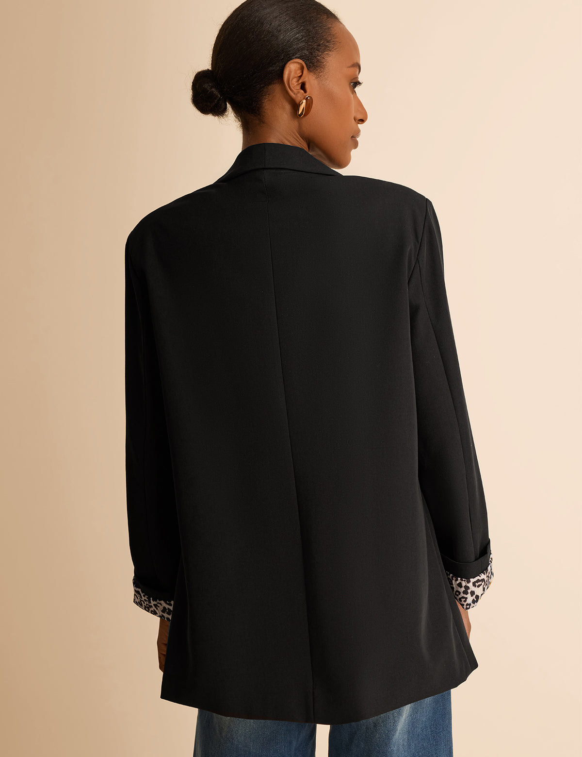 CicyBell Women's Black Business Casual Blazer with a chic shawl collar and leopard print lining. A professional model styles this open-front stretch work jacket with denim jeans and a white top for a modern office-to-evening look.