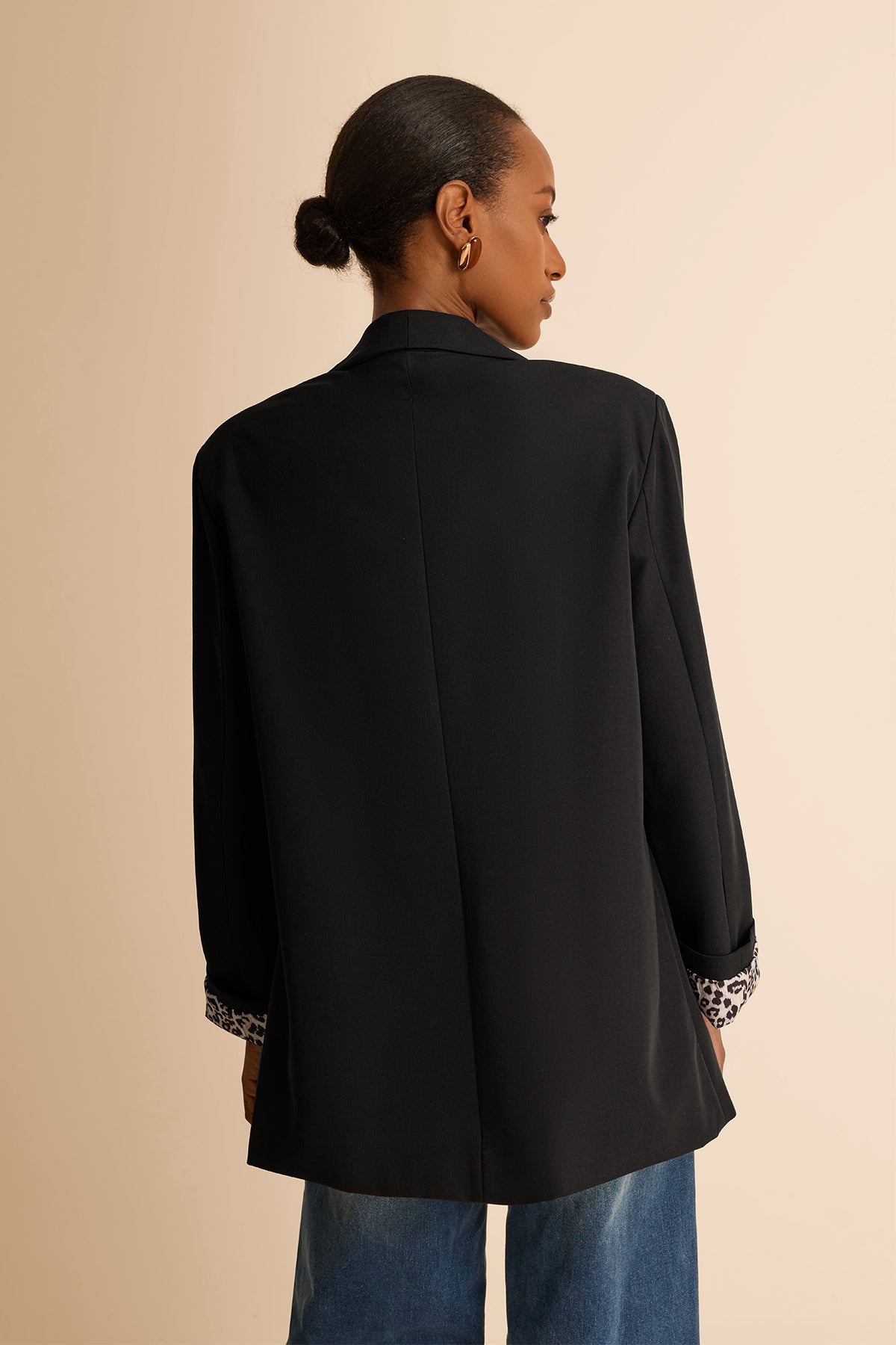 CicyBell Women's Black Business Casual Blazer with a chic shawl collar and leopard print lining. A professional model styles this open-front stretch work jacket with denim jeans and a white top for a modern office-to-evening look.