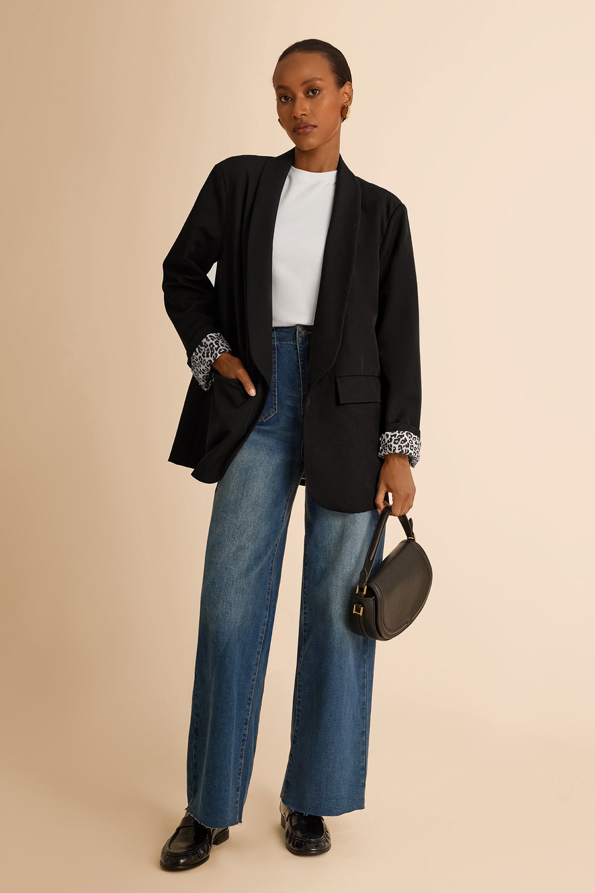 CicyBell Women's Black Business Casual Blazer with a chic shawl collar and leopard print lining. A professional model styles this open-front stretch work jacket with denim jeans and a white top for a modern office-to-evening look.