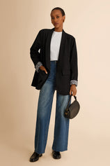 CicyBell Women's Black Business Casual Blazer with a chic shawl collar and leopard print lining. A professional model styles this open-front stretch work jacket with denim jeans and a white top for a modern office-to-evening look.