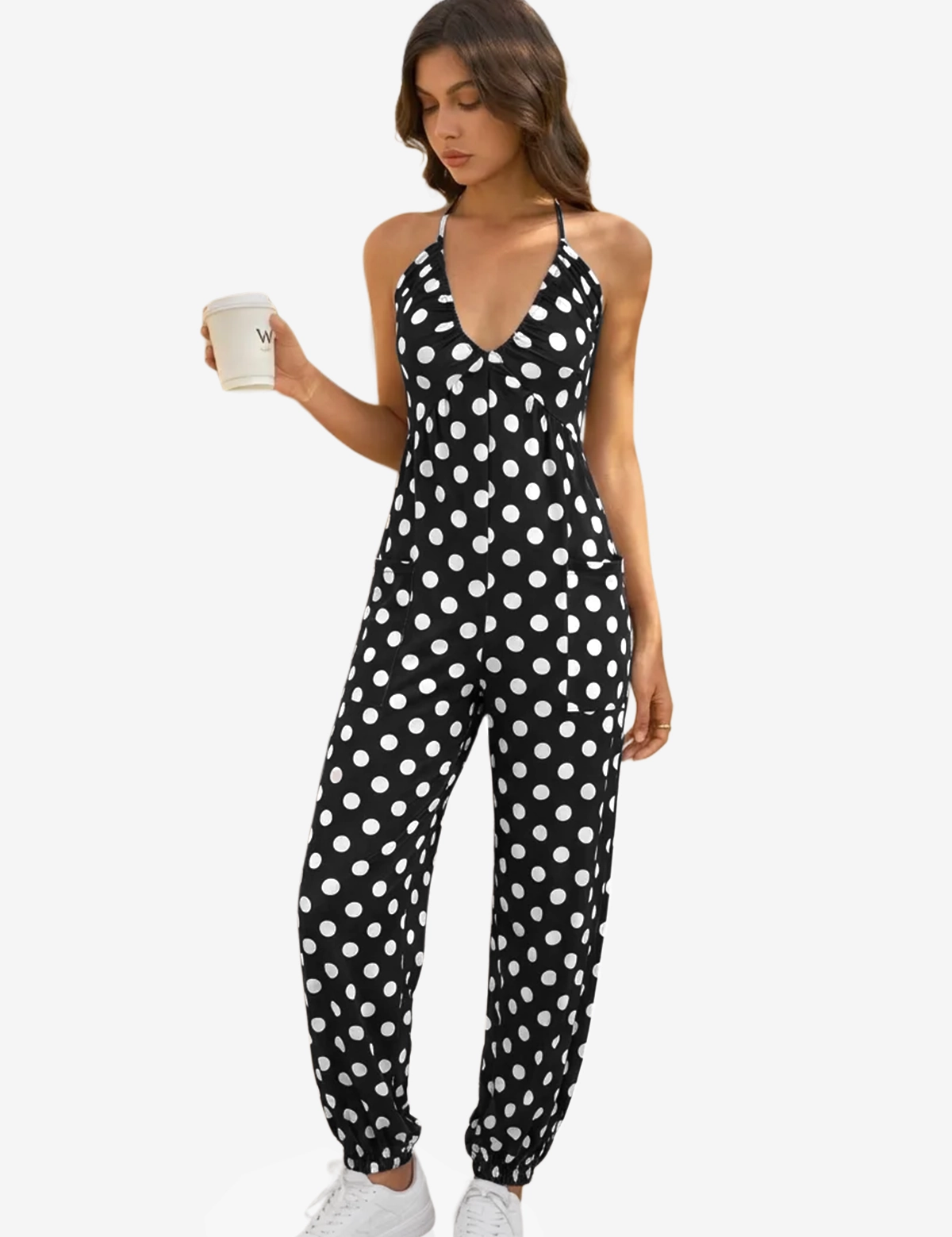 A bold and vibrant Cicy Bell halter neck jumpsuit in a breezy, lightweight fabric. Highlights the flattering plunging V-neckline and relaxed jogger silhouette, designed as a "one-and-done" vacation essential for beachside brunches or sunset parties.