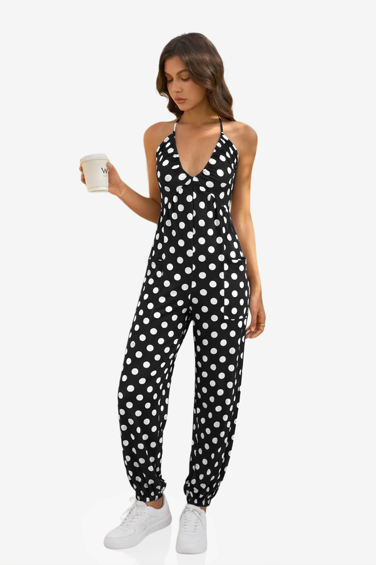 A bold and vibrant Cicy Bell halter neck jumpsuit in a breezy, lightweight fabric. Highlights the flattering plunging V-neckline and relaxed jogger silhouette, designed as a "one-and-done" vacation essential for beachside brunches or sunset parties.