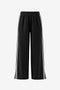 CicyBell Women's High-Waisted Wide-Leg Pants with bold contrasting side stripes. These sporty-chic trousers feature a comfortable elastic waistband and modern side slits for an effortlessly fashionable travel look.