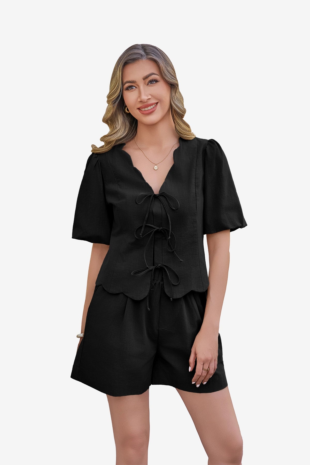CicyBell Women's Black 2 Piece Set in 100% cotton. A model showcases the tie-front puff sleeve top with a romantic ruffle V-neck and matching high-waisted wide-leg shorts, perfect for a coordinated summer loungewear or beach look.