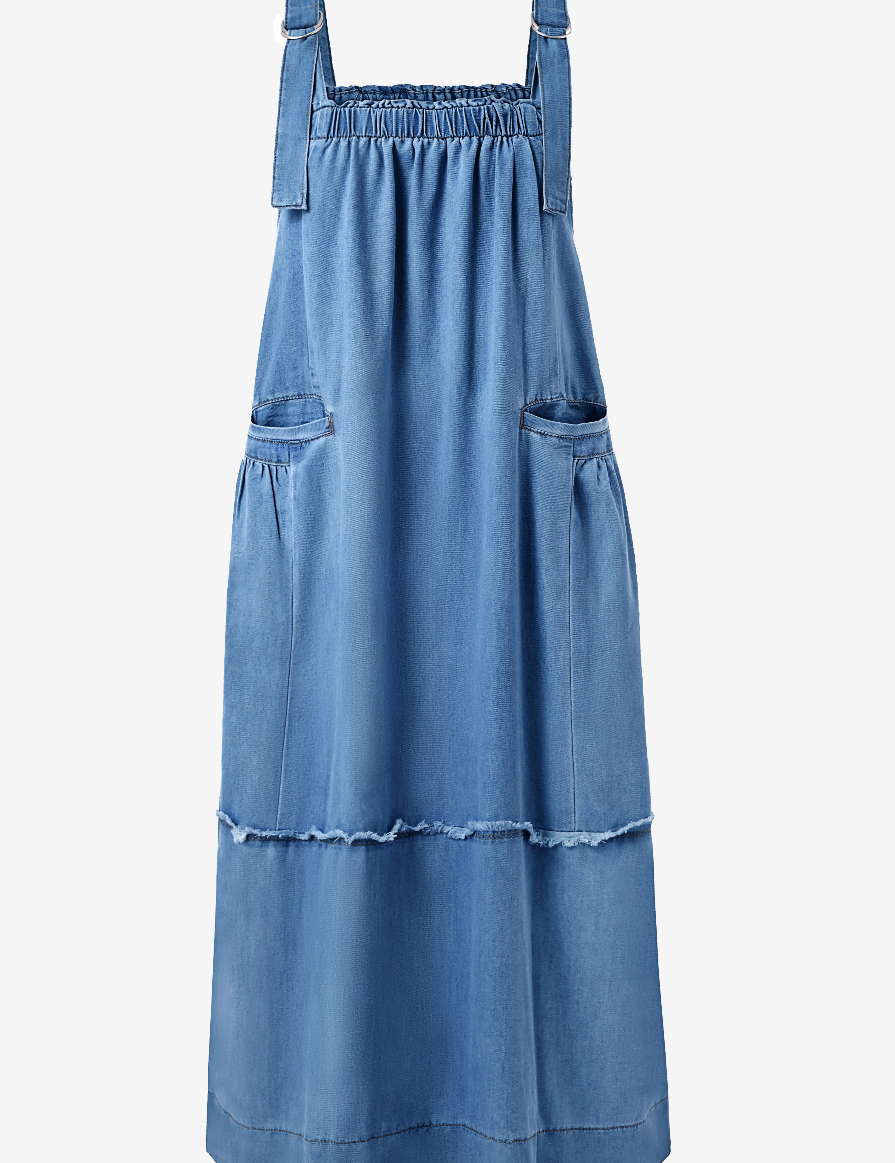 A modern boho-chic Cicy Bell denim maxi dress with a multi-tiered silhouette and shabby-chic fringe accents. Highlights the adjustable metal buckles and oversized aesthetic, perfect for layering over tees or sweaters for farmers' market runs or casual coffee dates.