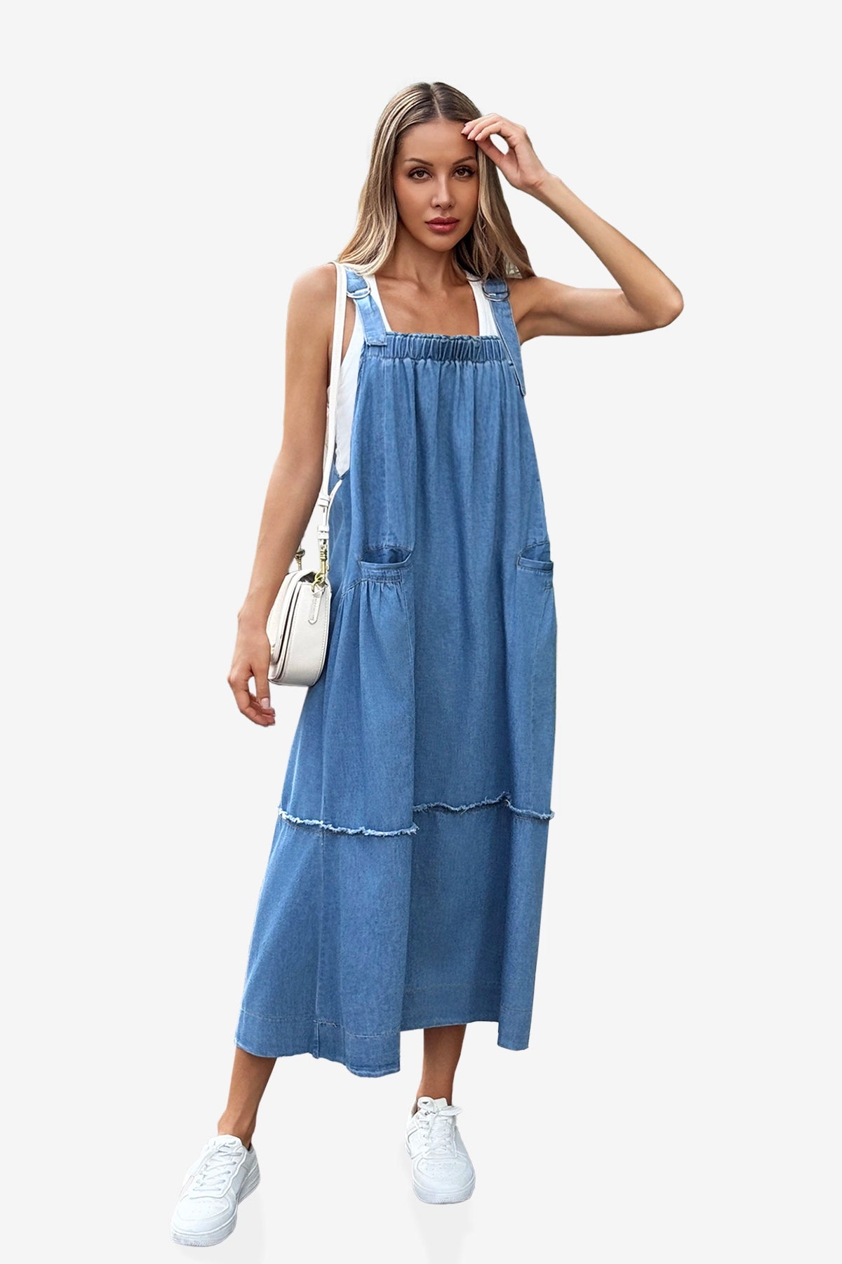 A modern boho-chic Cicy Bell denim maxi dress with a multi-tiered silhouette and shabby-chic fringe accents. Highlights the adjustable metal buckles and oversized aesthetic, perfect for layering over tees or sweaters for farmers' market runs or casual coffee dates.