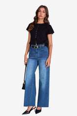 Cicy Bell Women's High-Waisted Wide-Leg Jeans featuring unique side patch pockets and a trendy frayed hem. These light blue stretchy denim pants offer a vintage-inspired straight-leg silhouette for coffee dates or nights out.