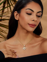 Cicy Bell Women's Floral Square Pendant Necklace in 18k gold-plated brass. Features a geometric square frame with an intricate "sparkle-within-a-square" design using round and baguette-cut Cubic Zirconia stones.
