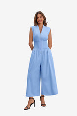 Cicy Bell Women's V-Neck Jumpsuit featuring a bold exposed front zipper and a flattering smocked waist. This one-and-done wide-leg outfit offers a sophisticated silhouette and functional side pockets for summer weddings or casual nights out.