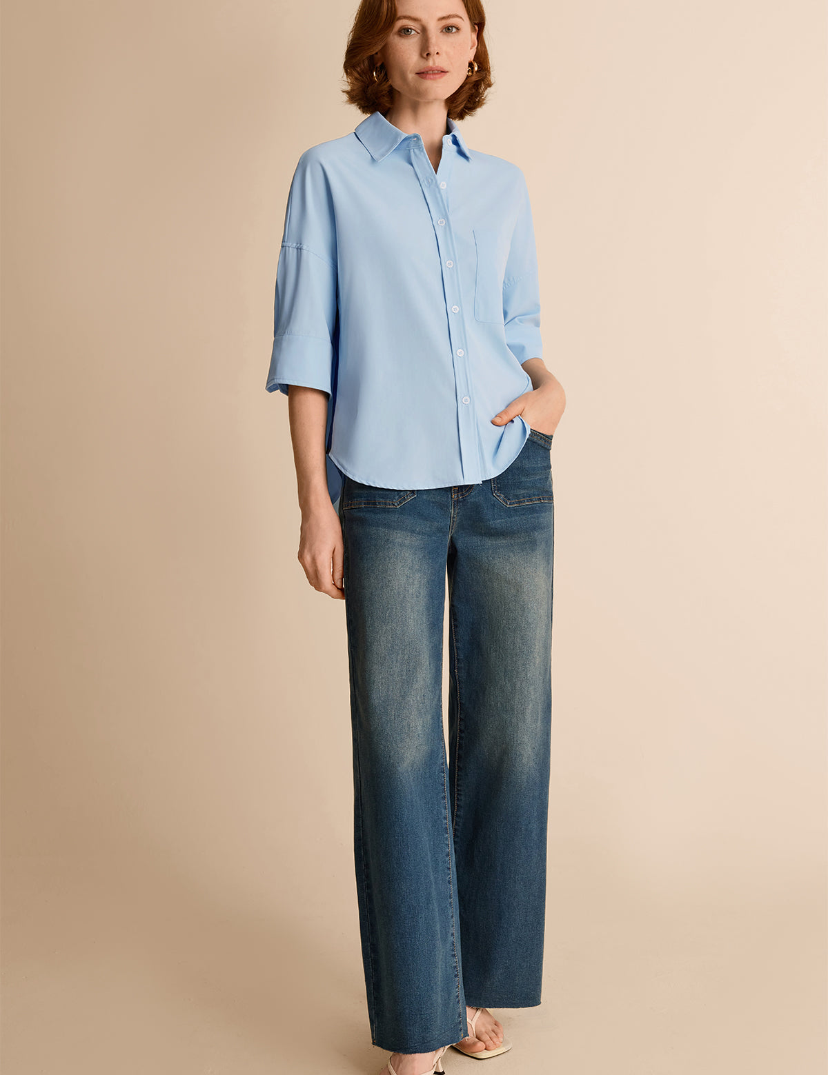 Smart casual summer outfit with a sky blue button-down shirt paired with wide-leg blue jeans