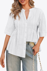 A textured CicyBell pleated peplum blouse for women. Highlights the unique layered aesthetic from the front and back pleating and functional button closure. Crafted from breathable, wrinkle-resistant cotton for an effortlessly put-together summer style.