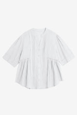 A textured CicyBell pleated peplum blouse for women. Highlights the unique layered aesthetic from the front and back pleating and functional button closure. Crafted from breathable, wrinkle-resistant cotton for an effortlessly put-together summer style.